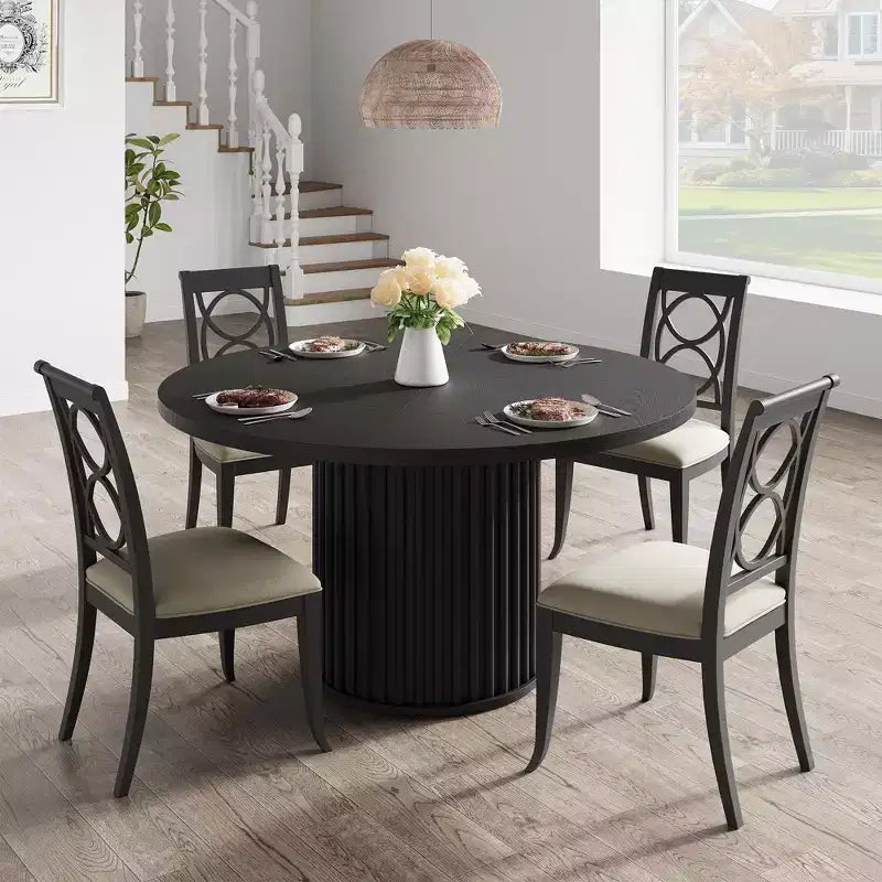 Tavolo da pranzo rotondo da 120 cm per 4-6 persone, piano in MDF nero con base a piedistallo in metallo ondulato